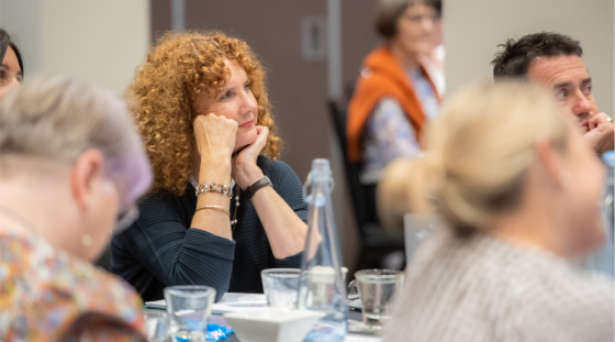 A woman at a conference learning about governance.